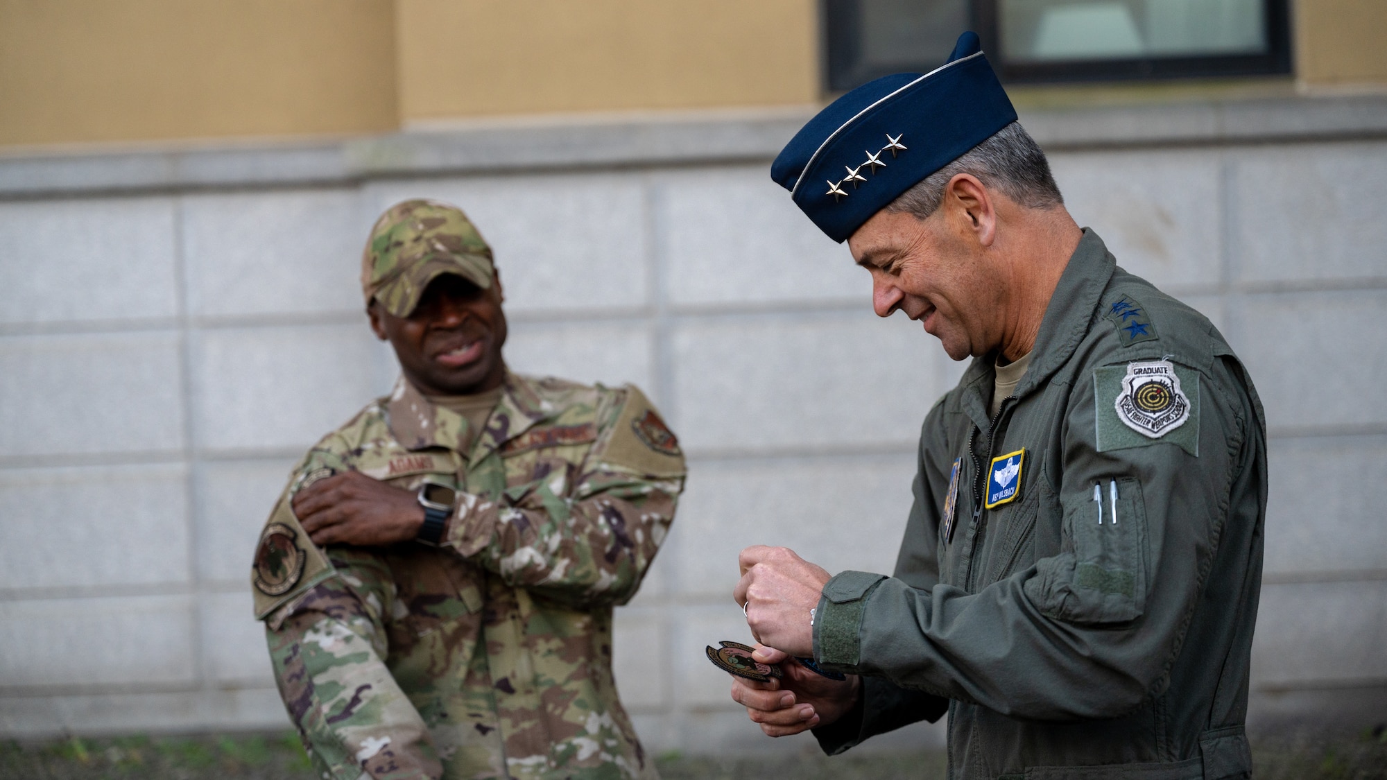 Gen. Ken Wilsbach is given a squadron patch by Master Sgt. Allen Adams.