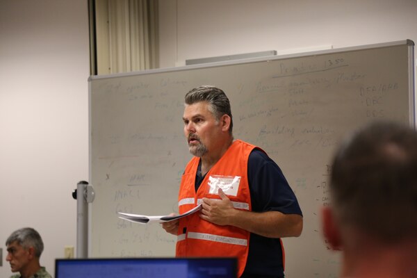 Naval Health Clinic Lemoore's Emergency Manager Karl Kassner, works with the incident management team to debrief the clinic's response during the The Great ShakeOut.