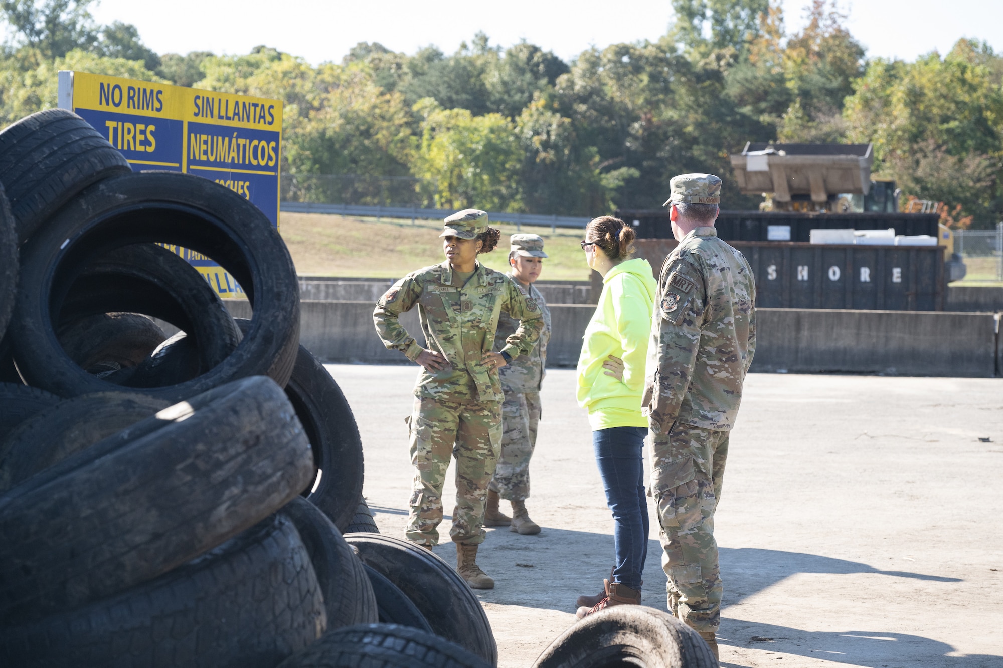 Lynsey Baer, center, Delaware Solid Waste Authority chief engineer, shows Chief Master Sgt. Carolyn Russell, left, 436th Airlift Wing command chief and her team, a pile of discarded tires at the Central Solid Waste Management Center in Felton, Delaware, Oct. 19, 2023. The command chief visited the center with members of her staff to gain a better understanding of solid waste management and increase recycling efforts on Dover Air Force Base. (U.S. Air Force photo by Mauricio Campino)