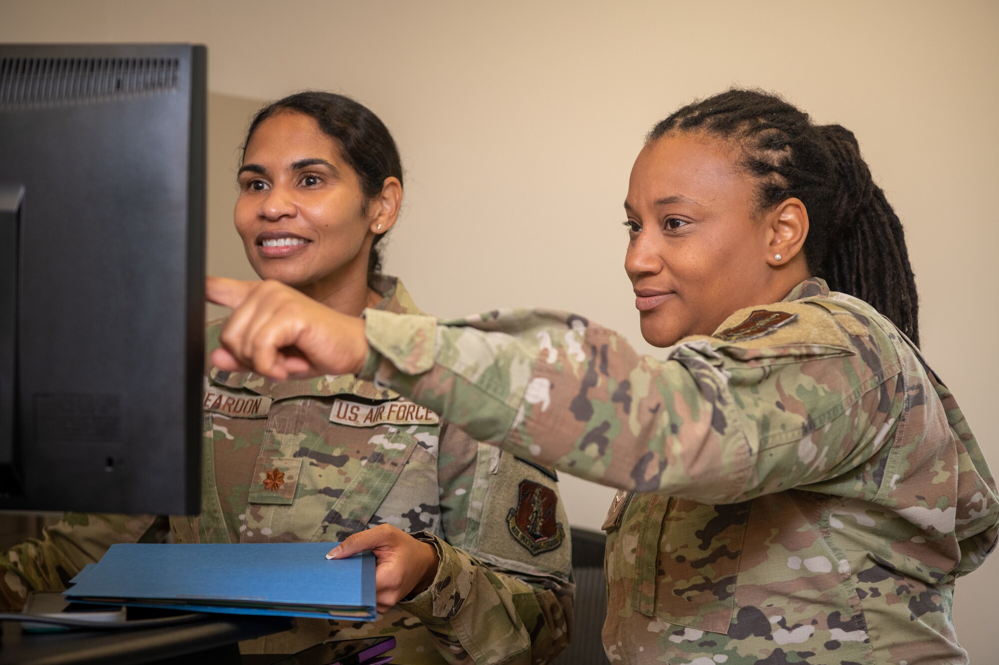 Two Airmen looking at a computer.
