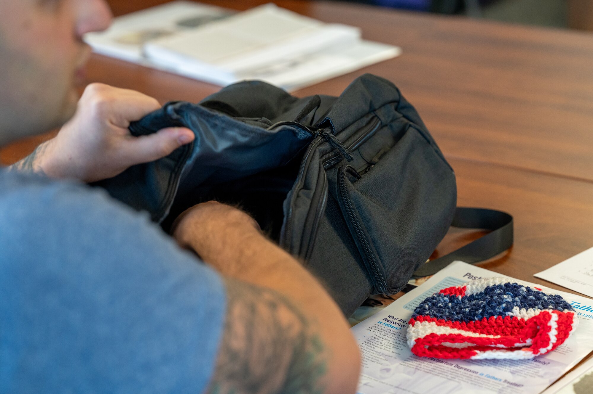 An airman reaches into a bag