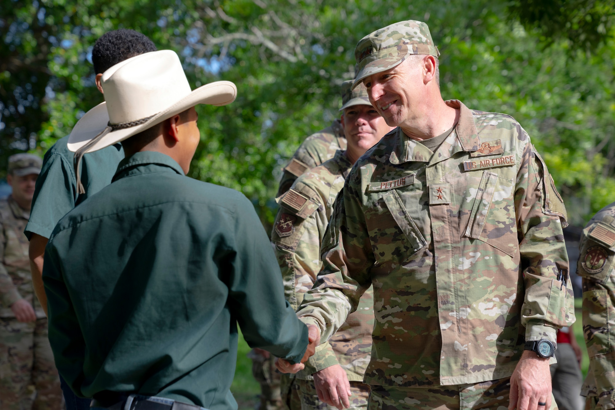U.S. Maj. Gen. Evan Pettus, 12th Air Force (Air Forces Southern) commander shakes hands with a student from the System of Technological and Agricultural Innovation (SCITA) in Comayagua, Honduras, Aug. 4, 2023. AFSOUTH remains committed to shared values with partner nations in achieving responsible stewardship of the environment in a shared neighborhood. (U.S. Air Force photo by Tech. Sgt. Rachel Maxwell)