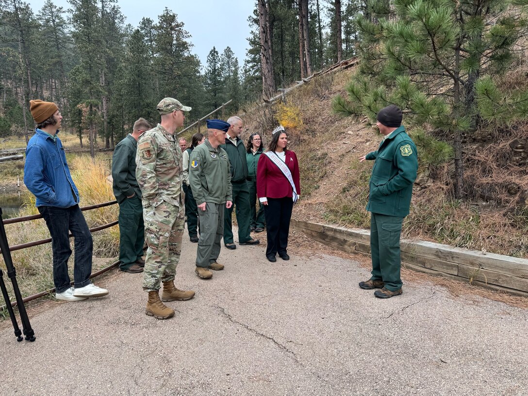 Ben Schumaker, right, Black Hills National Forest Recreation Staff Officer for Mystic Ranger District, leads Ellsworth Air Force Base leadership on a walking tour of Veteran’s Point Trail on the Pactola Reservoir, South Dakota, October 24, 2023.