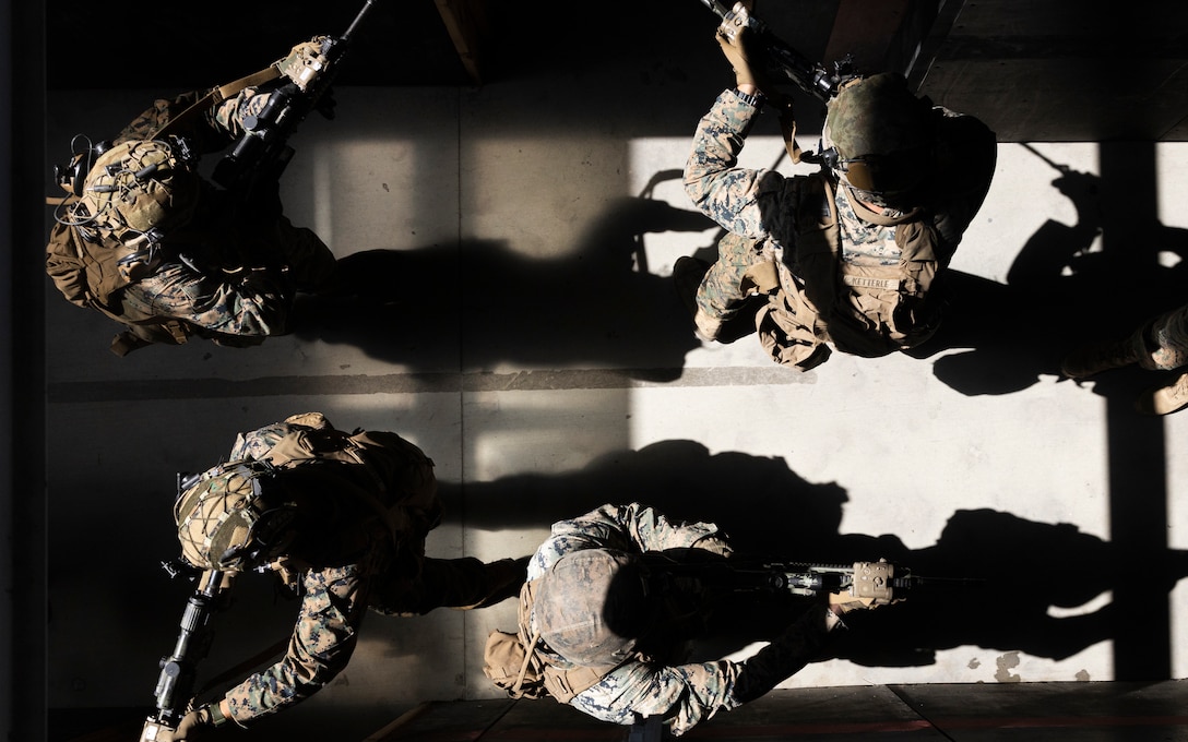 U.S. Marines with 1st Battalion, 4th Marine Regiment, 1st Marine Division, clear a hallway during a raid leaders course hosted by Expeditionary Operations Training Group, I Marine Expeditionary Force, at Marine Corps Base Camp Pendleton, California, Sept. 28, 2023. Instructors with EOTG trained the Marines to help enhance their tactics, techniques, and procedures for raid operations for future deployments. EOTG is a section of the I MEF command element that trains and evaluates deploying Marine Expeditionary Units, and other designated forces, in select individual and collective tasks to prepare them to support geographic combatant commands. (U.S. Marine Corps photo by Sgt. Cristian Bestul)