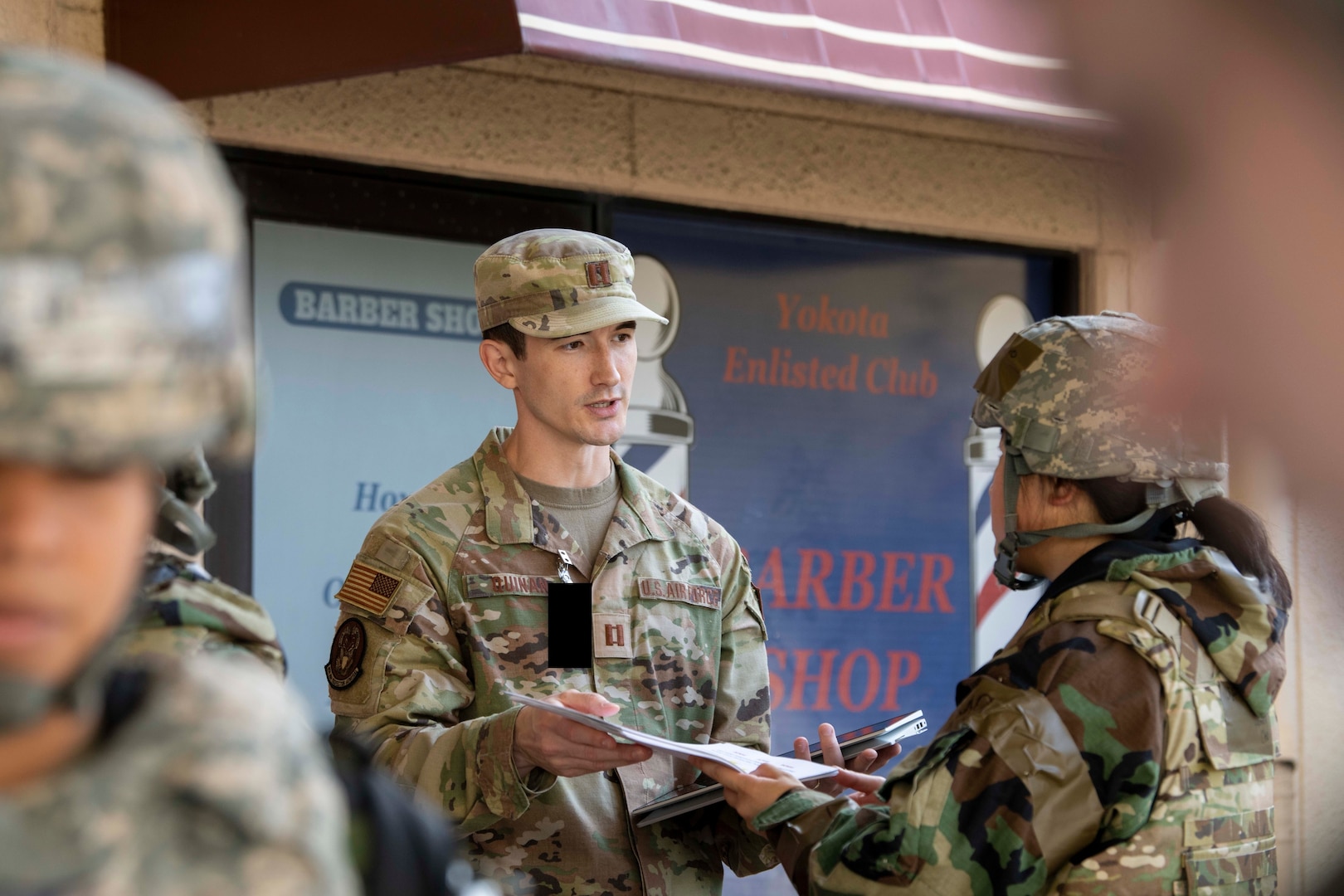 A Captain hands out documents.