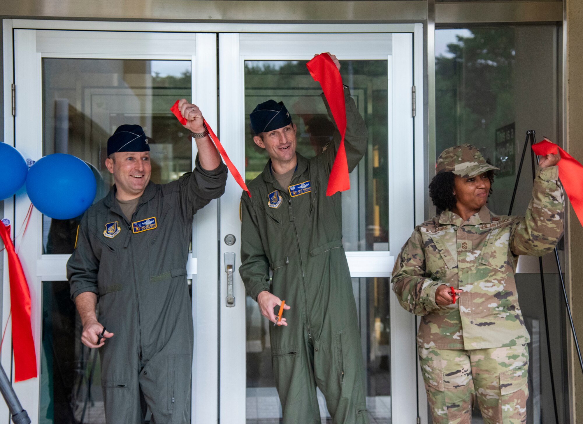 U.S. Air Force 35th Fighter Wing leadership hold up pieces of a ribbon during a ribbon cutting ceremony at Misawa Air Base, Japan, Oct. 5, 2023.