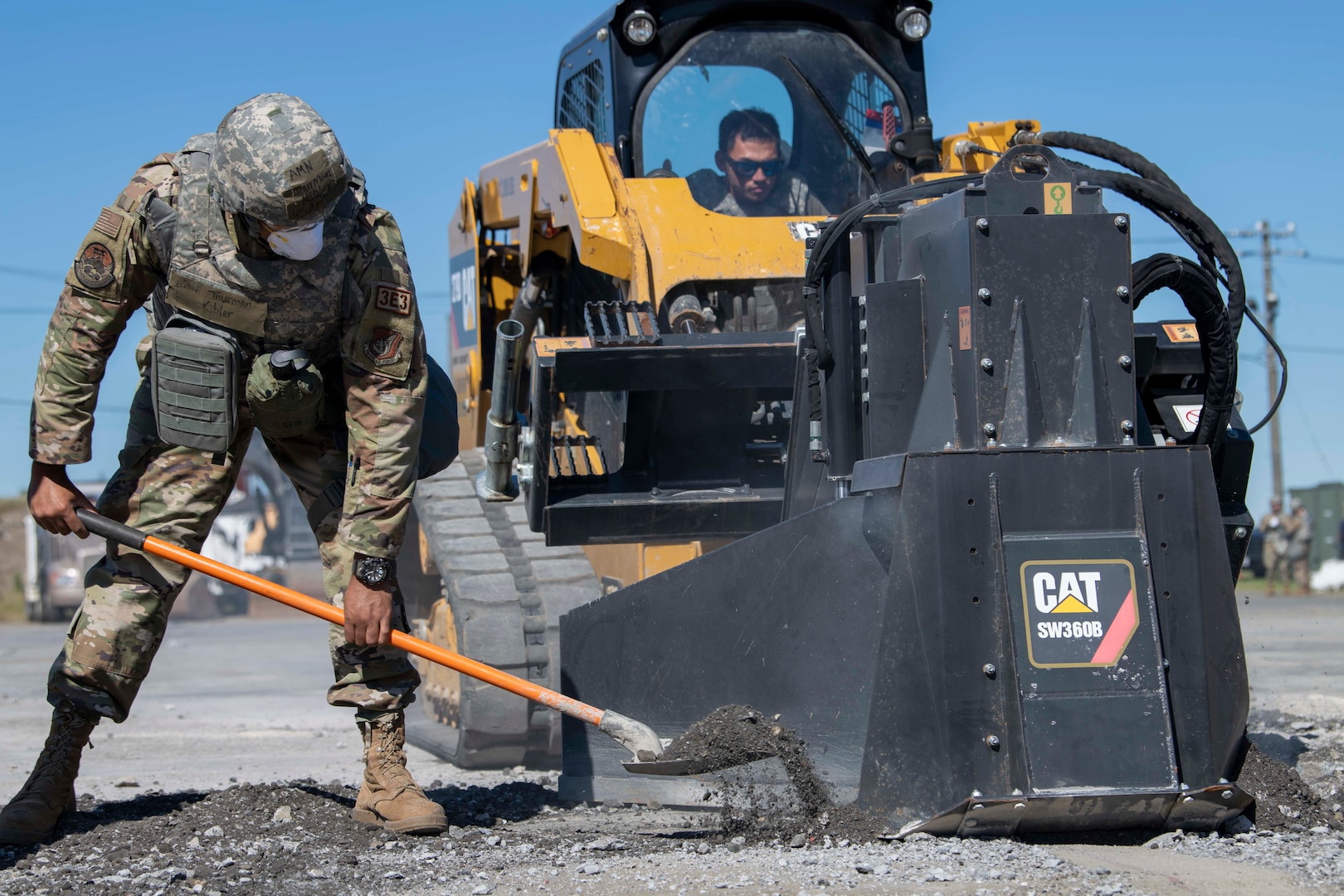 An Airman shovels debris during rapid airfield damage repair.