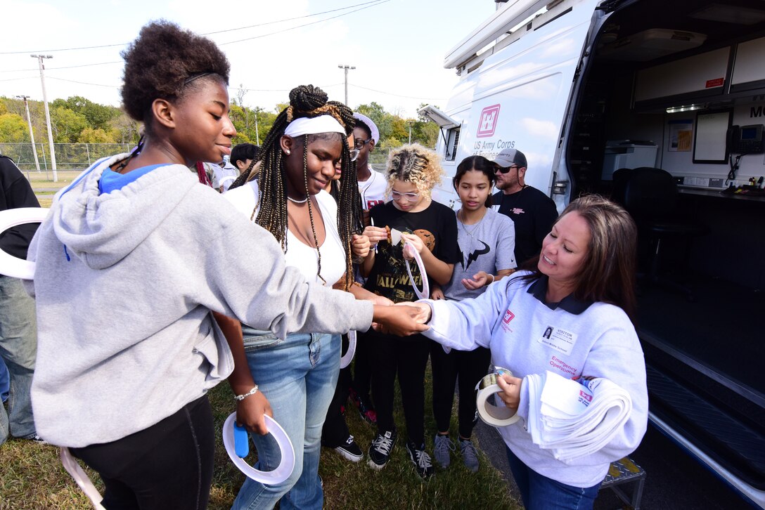 Adrienne Bostic (Right) in Emergency Management hands out water safety goodies while showcasing a command-and-control vehicle with Antioch Middle School students during a Tennessee STEAM Festival event Oct. 17, 2023, in Antioch, Tennessee. The U.S. Army Corps of Engineers Nashville District partnered with the school to “show and tell” about the careers related to science, technology, engineering, arts, and mathematics. (USACE Photo by Lee Roberts)