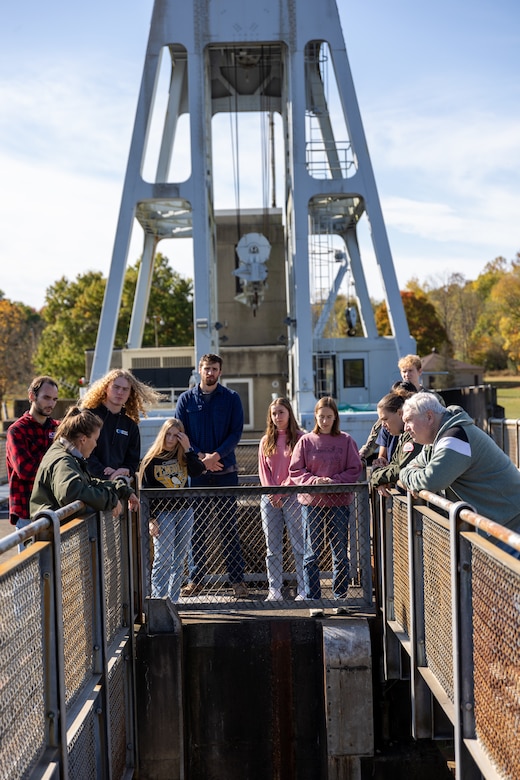 In a convergence of academia and real-world engineering, a group of students from the University of Pittsburgh’s Hydrologic Analysis and Design course explored the Conemaugh River Dam to expand their engineer learning beyond conventional classroom boundaries. University of Pittsburgh students view the Conemaugh River Dam from the top looking down as April Richards, a park ranger with the U.S. Army Corps of Engineers Pittsburgh District, explains the dam’s construction in Saltsburg, Pennsylvania, Oct. 13, 2023.