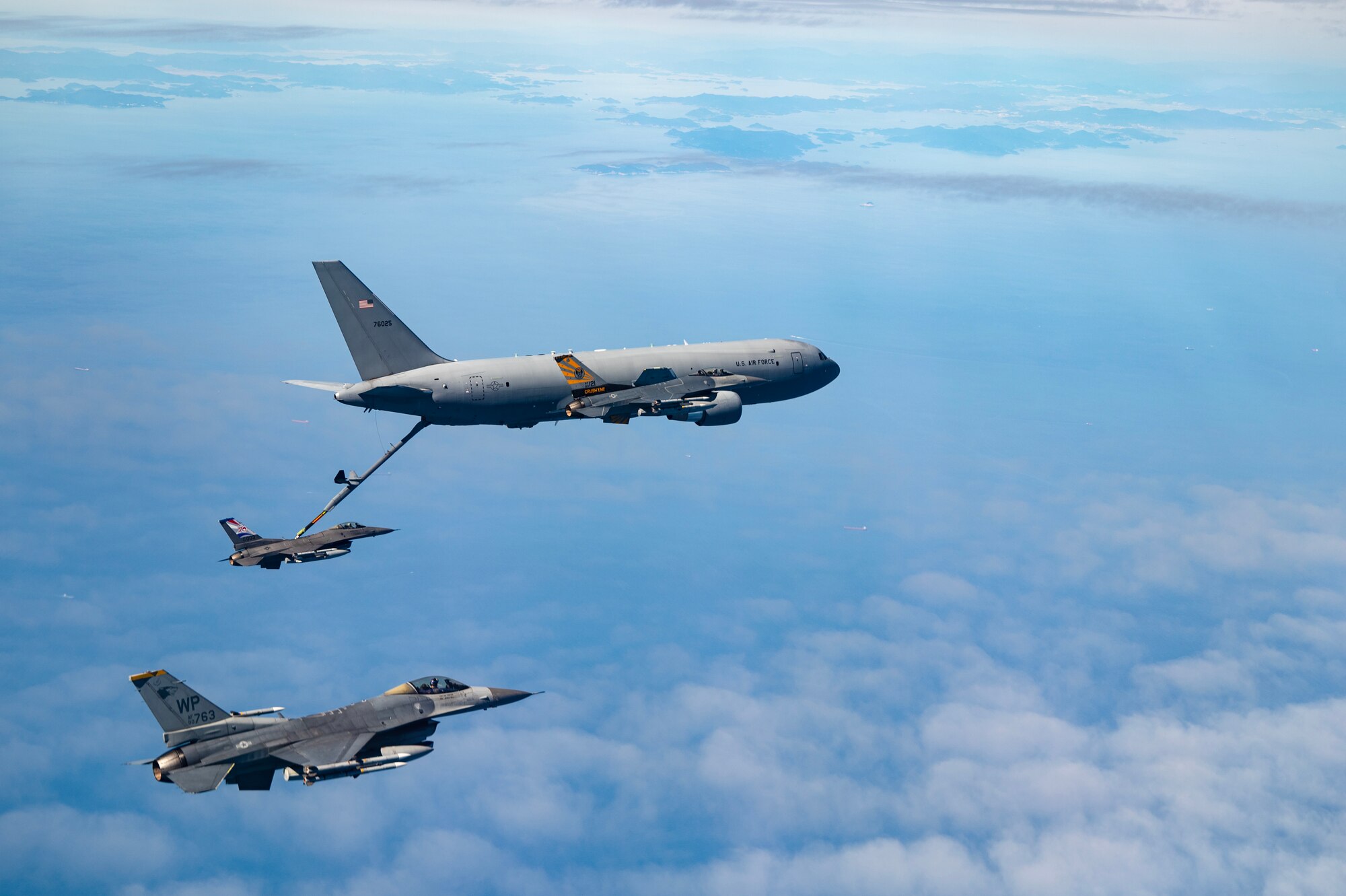A U.S. Air Force KC-46 Pegasus, right, refuels a U.S. Air Force F-16 Fighting Falcon, center, over the Indo-Pacific.