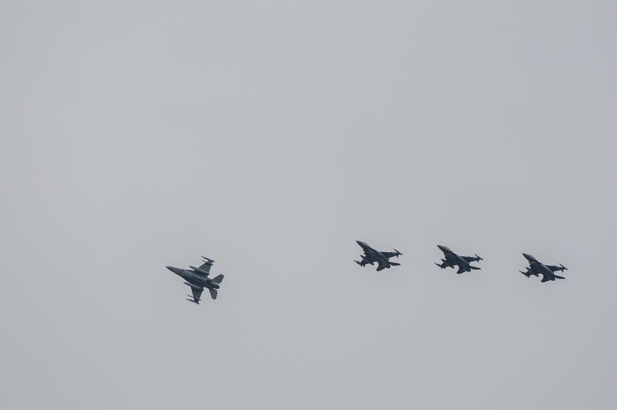 U.S. Air Force F-16 Fighting Falcons perform aerial maneuvers before landing.