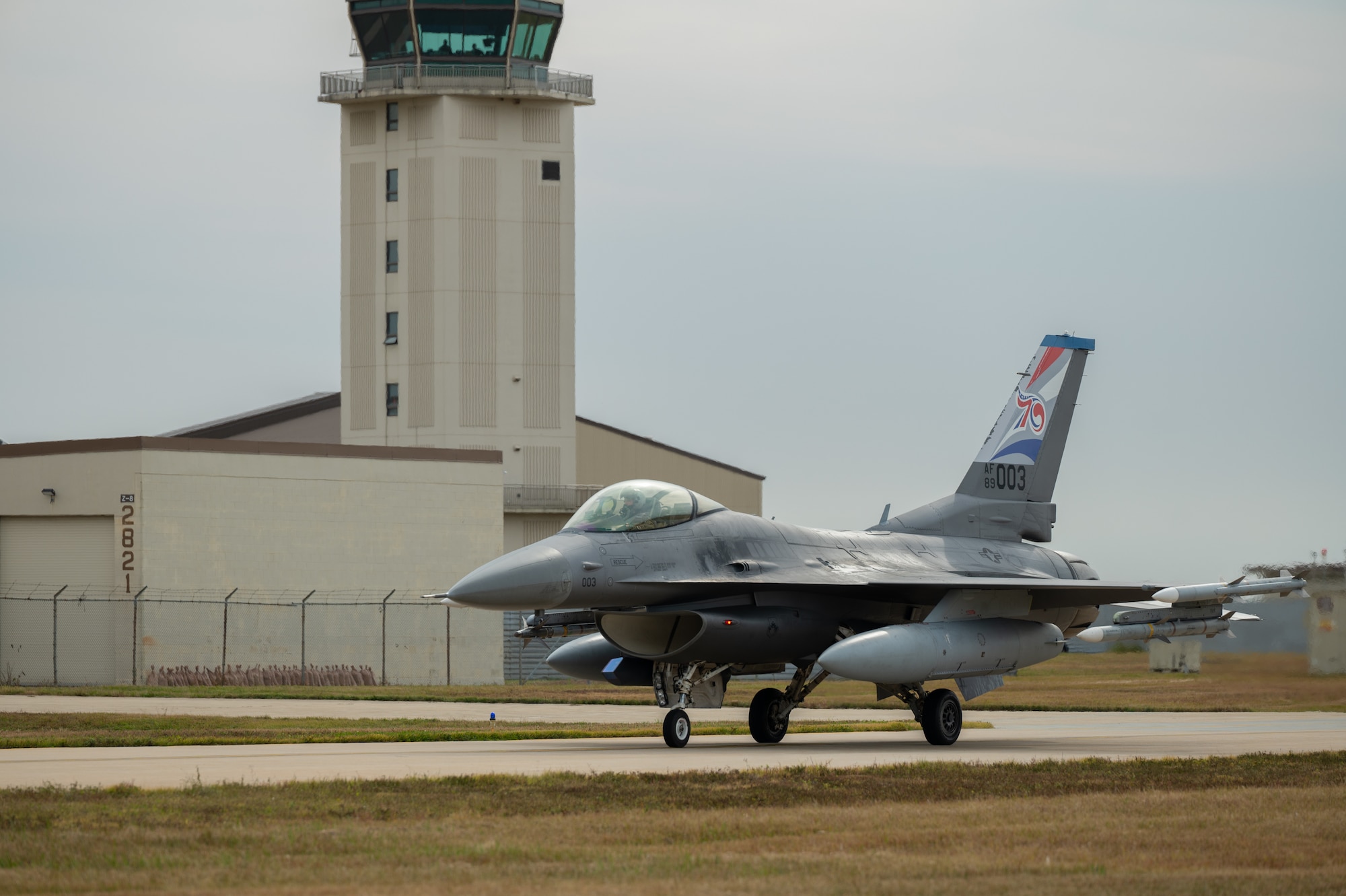 A U.S. Air Force F-16 Fighting Falcon taxis on the runway upon mission return.