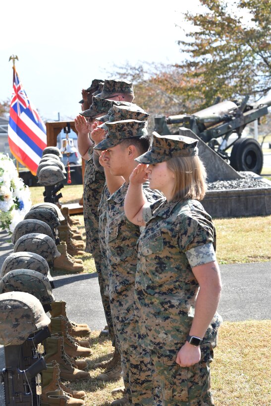 Camp Fuji Marines salute displays for the fallen during the memorial ceremony commemorating the deadly 1979 fire. (U.S. Marine Corps photo by Song Jordan)