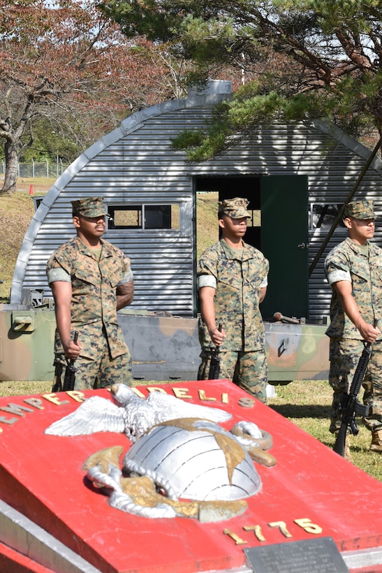 CATC Camp Fuji Marines stand in front of a Quonset hut, similar to the ones that caught fire during the 1979 fire, during the memorial ceremony commemorating the deadly fire. (U.S. Marine Corps photo by Song Jordan)