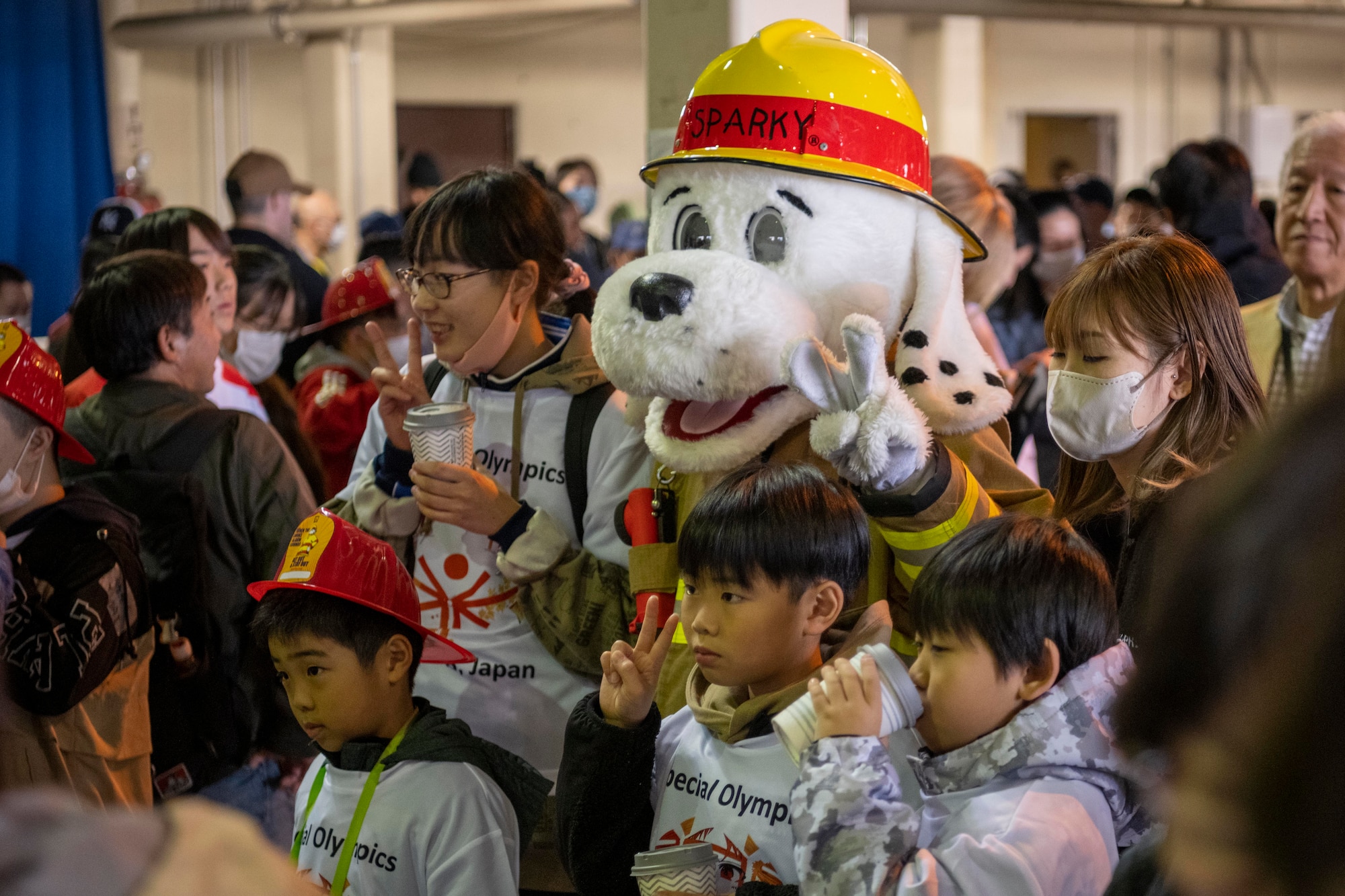 Attendees pose for a photo with a fire station mascot during the 2023 Misawa Special Olympics at Misawa Air Base, Japan.