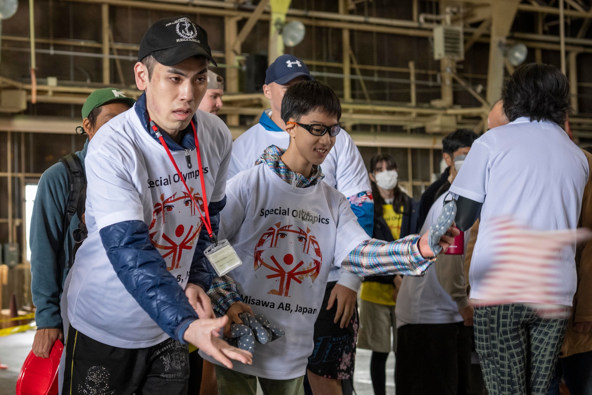 Athletes throw bean bags while playing cornhole during the 2023 Misawa Special Olympics at Misawa Air Base, Japan.