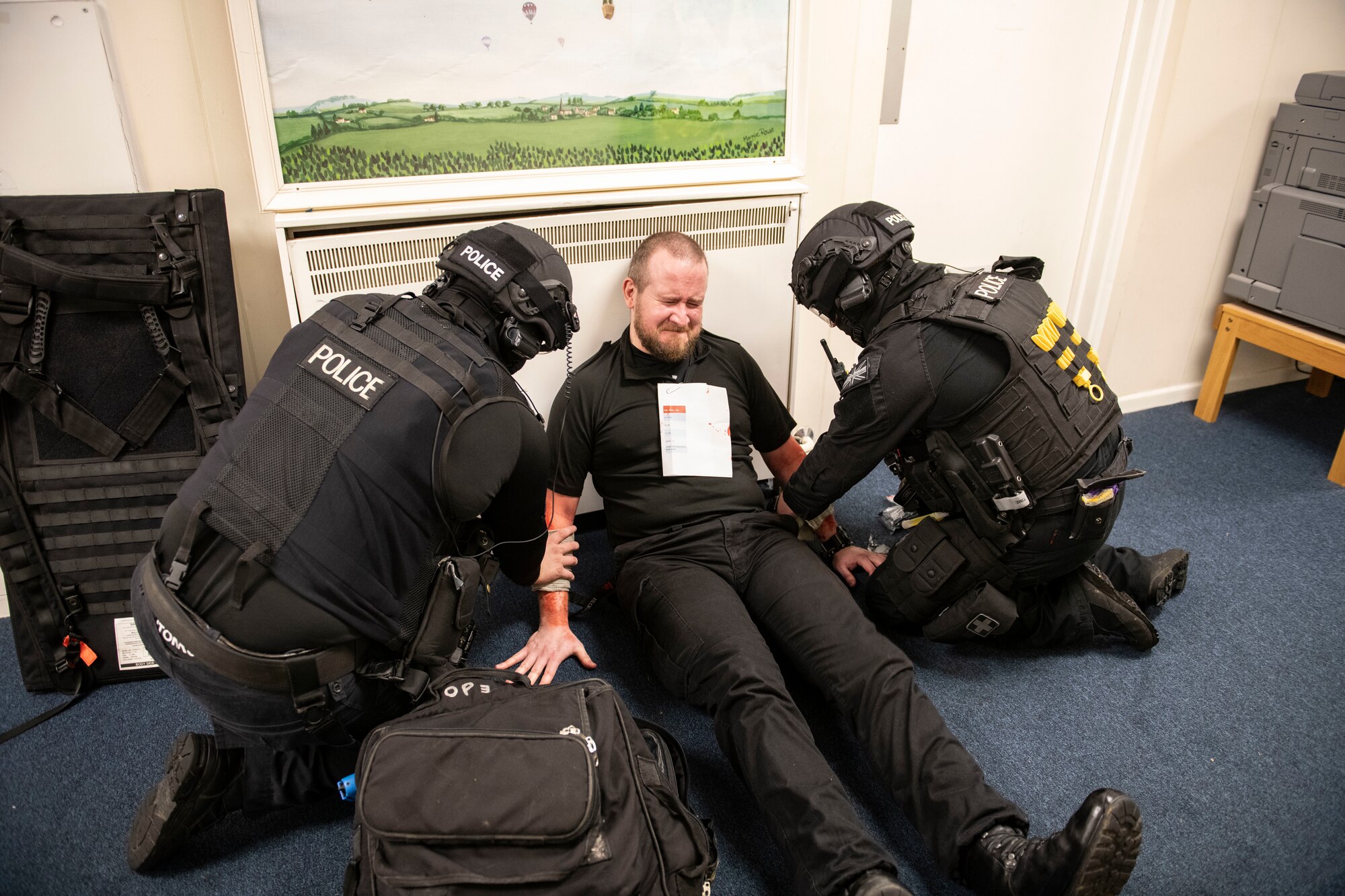 Ministry of Defense Police provide care to a volunteer’s simulated injuries during an exercise at RAF Croughton