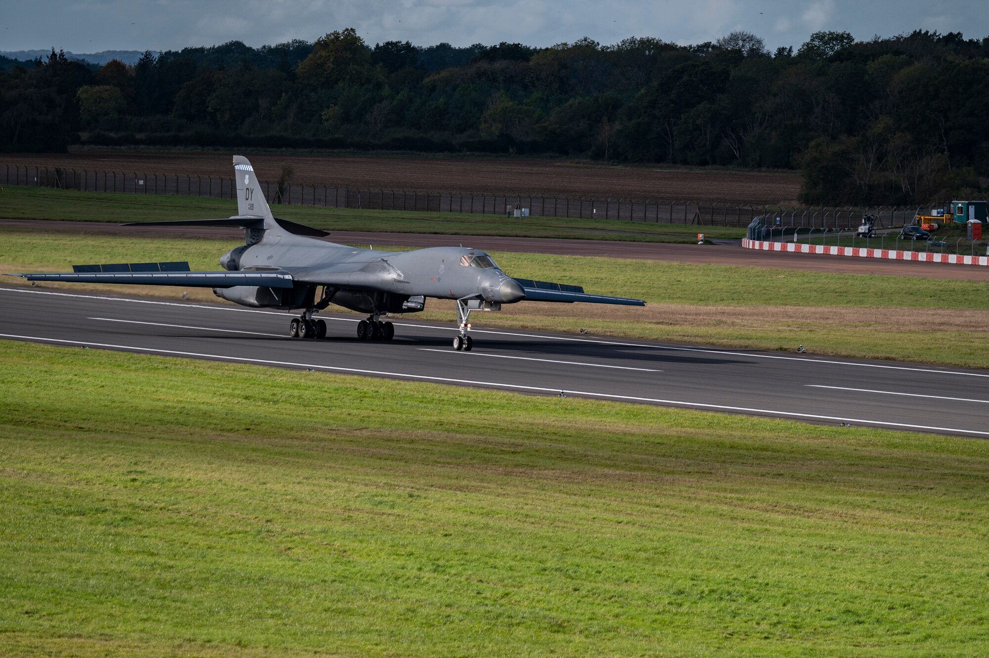 A B-1B Lancer assigned to the 9th Expeditionary Bomb Squadron lands at RAF Fairford, United Kingdom, Oct. 24, 2023. U.S. Air Forces in Europe routinely hosts and supports a variety of U.S. Air Force aircraft and units for training to support geographic combatant command objectives. Operating with a variety of aircraft and units in Europe aids in maintaining a ready and postured force prepared to respond to and support global operations. (U.S. Air Force Photo by Senior Airman Ryan Hayman)