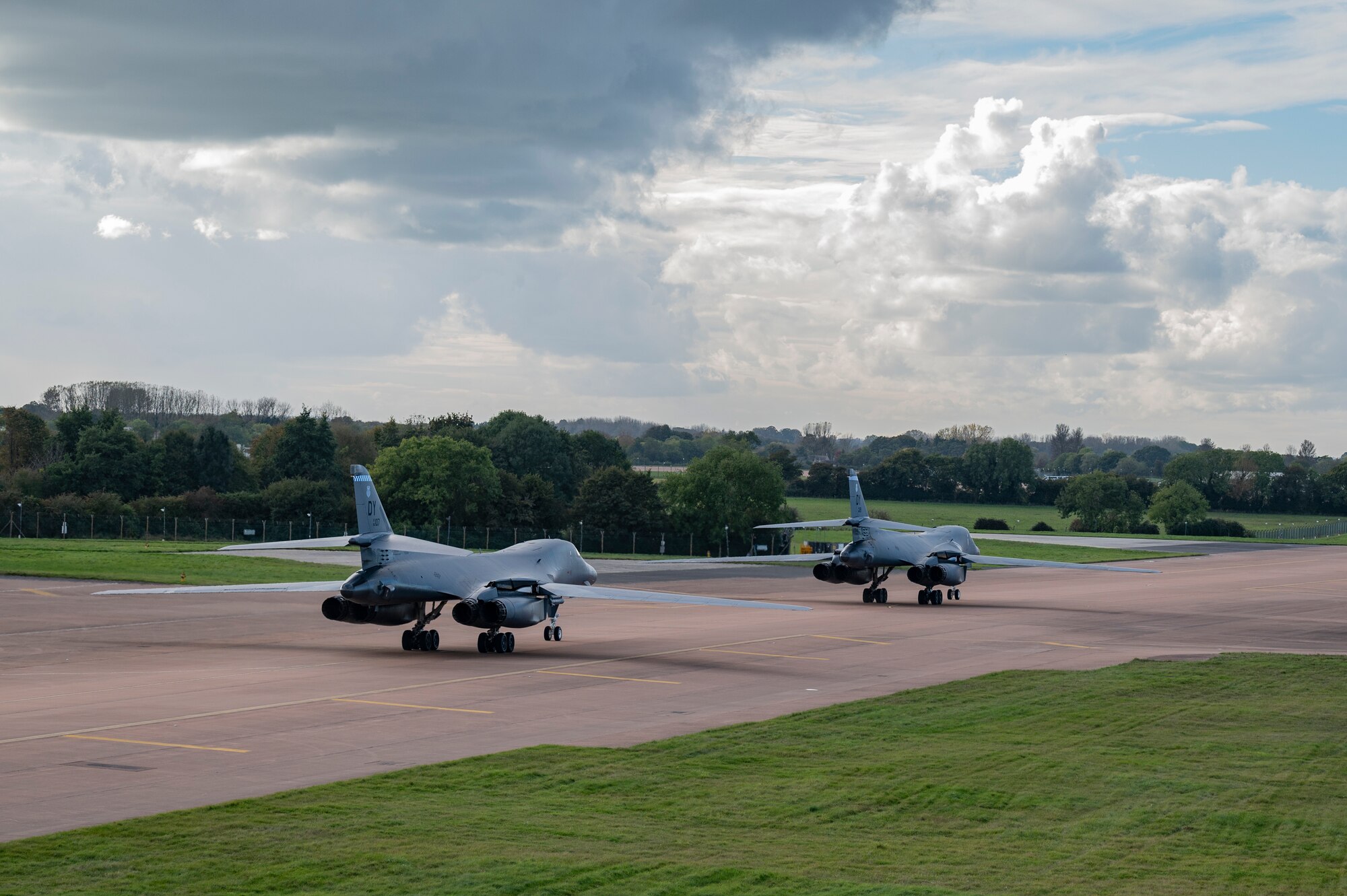 Two B-1B Lancers assigned to the 9th Expeditionary Bomb Squadron taxi on the flightline at RAF Fairford, United Kingdom, Oct. 12, 2023. The U.S. Air Force routinely deploys a variety of aircraft and units throughout Europe for training and to support geographic combatant command objectives. (U.S. Air Force Photo by Senior Airman Ryan Hayman)