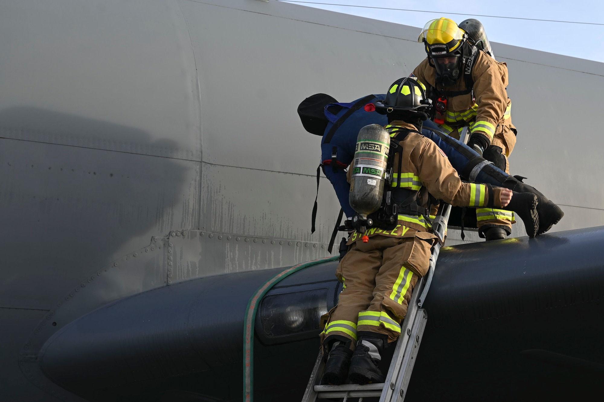 The 100th CES firefighters simulated personnel rescue procedures using an injured dummy from a KC-135 Stratotanker.