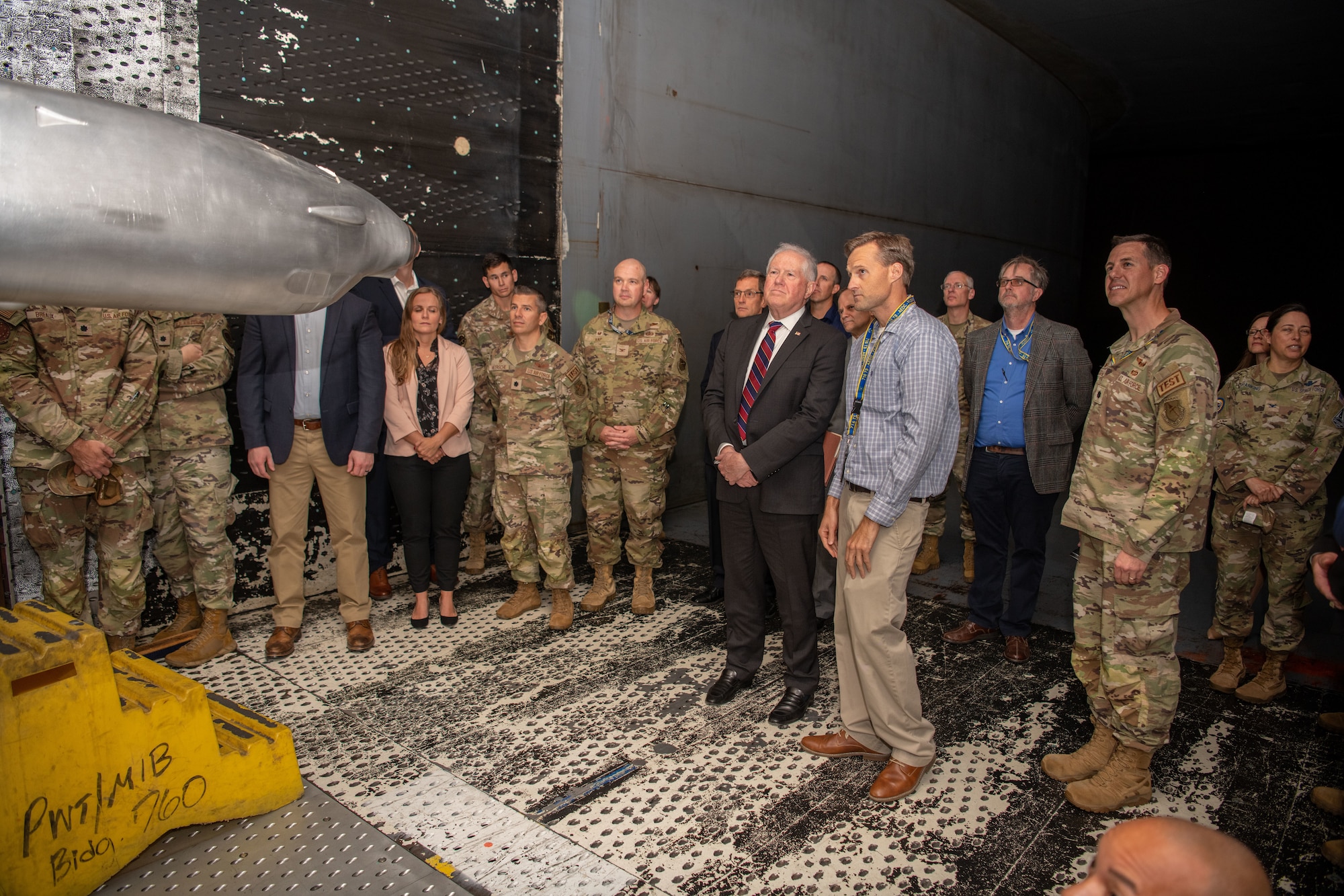 Secretary of the Air Force Frank Kendall, center, gets an up-close look at a test article in one of the wind tunnels at Arnold Air Force Base, Tenn., during his Oct. 4, 2023, visit. During his time at Arnold, headquarters of Arnold Engineering Development Complex, Kendall observed some base operations, toured several facilities and received overviews of current and planned AEDC test capabilities. (U.S. Air Force photo by Keith Thornburgh)