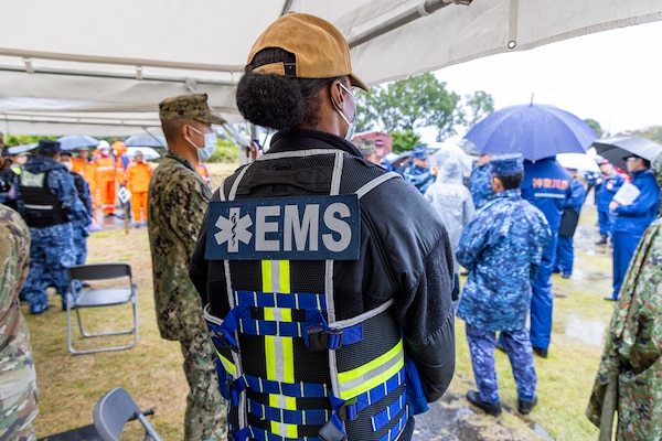 USNMRTC Yokosuka Sailor surveys the actions of joint partners during the Big Rescue Kanagawa mass causality exercise