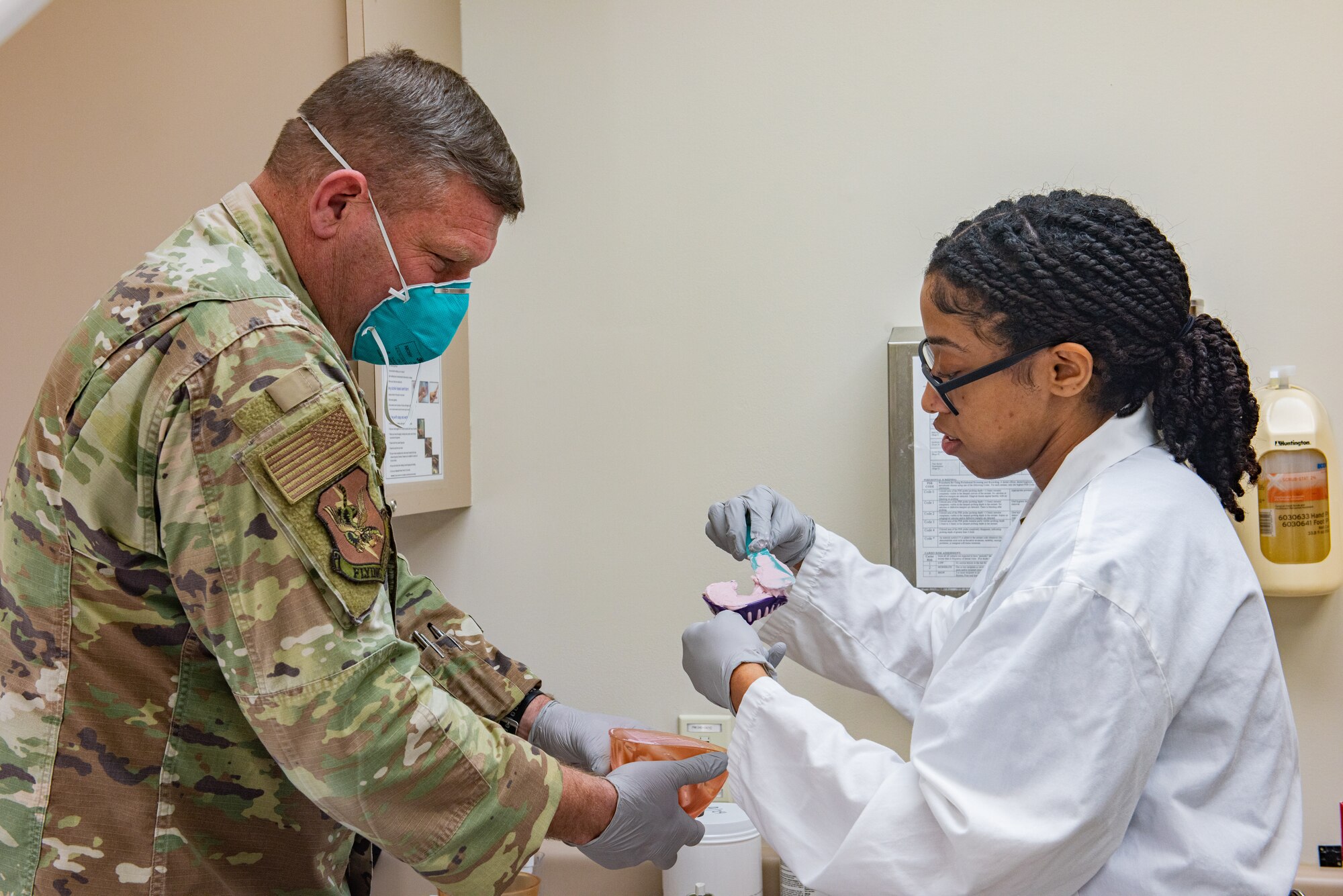 Airmen practice applying impressions and color staining a crown