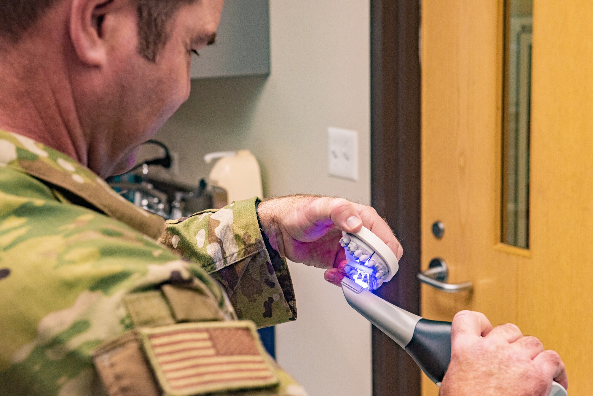 Airmen practice applying impressions and color staining a crown