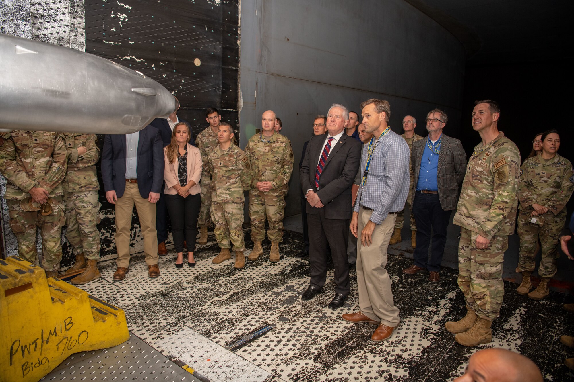 Secretary of the Air Force Frank Kendall, center, gets an up-close look at a test article in one of the wind tunnels at Arnold Air Force Base, Tenn., during his Oct. 4, 2023, visit. During his time at Arnold, headquarters of Arnold Engineering Development Complex, Kendall observed some base operations, toured several facilities and received overviews of current and planned AEDC test capabilities. (U.S. Air Force photo by Keith Thornburgh)