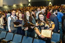 : Shop 26, Welders, apprentice class members (from left) Tyler Reynolds, Millie Stivers, Caitlin Sutter and Monika Westerfield celebrate as they exit the auditorium following the annual Puget Sound Naval Shipyard & Intermediate Maintenance Facility Apprentice Program graduation ceremony Sept. 29, 2023, at the Bremerton High School Performing Arts Center, in Bremerton, Washington.  (U.S. Navy photo by Jeb Fach)