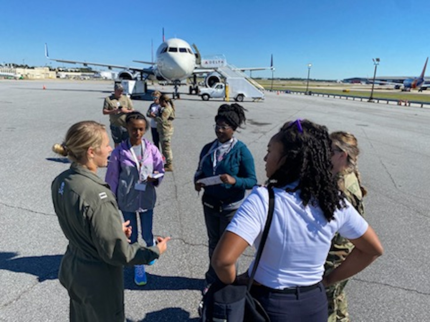 Pilots speak to children at an event