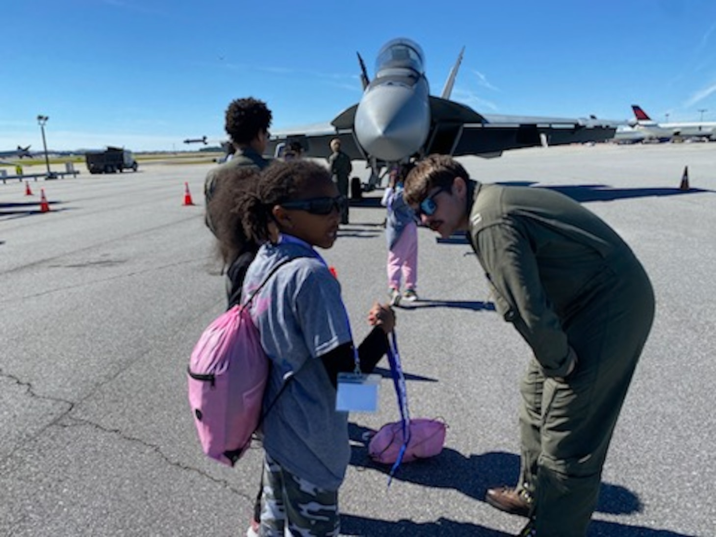 Pilots speak to children at an event