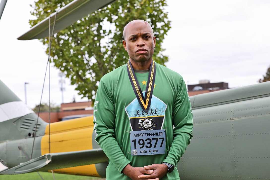 U.S. Army Reserve Master Sgt. Laroy Warren, G-1 Non-Commissioned Officer in Charge, IPPS-A Liaison, 85th U.S. Army Reserve Support Command, displays his finishers medal and shirt after recently completing the Army 10-Miler in Washington D.C.