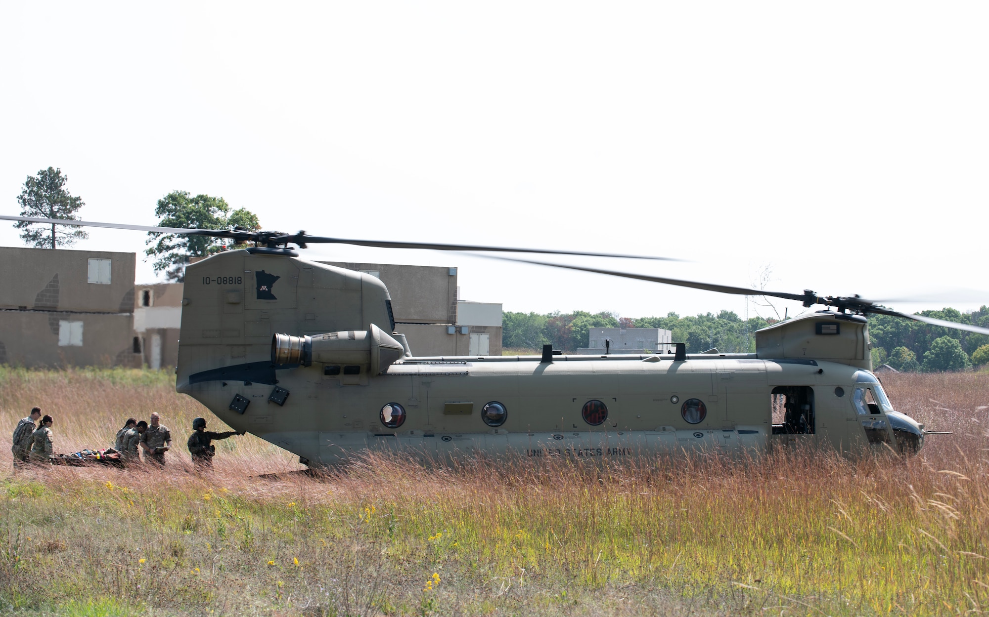 U.S. Air Force Airmen from the 133rd Medical Group, Detachment 1, load simulated patient onto a CH-47 Chinook from C Company, 2nd Battalion, 211th Aviation Regiment, General Support Aviation Battalion, Minnesota Army National Guard, in Little Falls, Camp Ripley, Minn., Aug. 28, 2023.