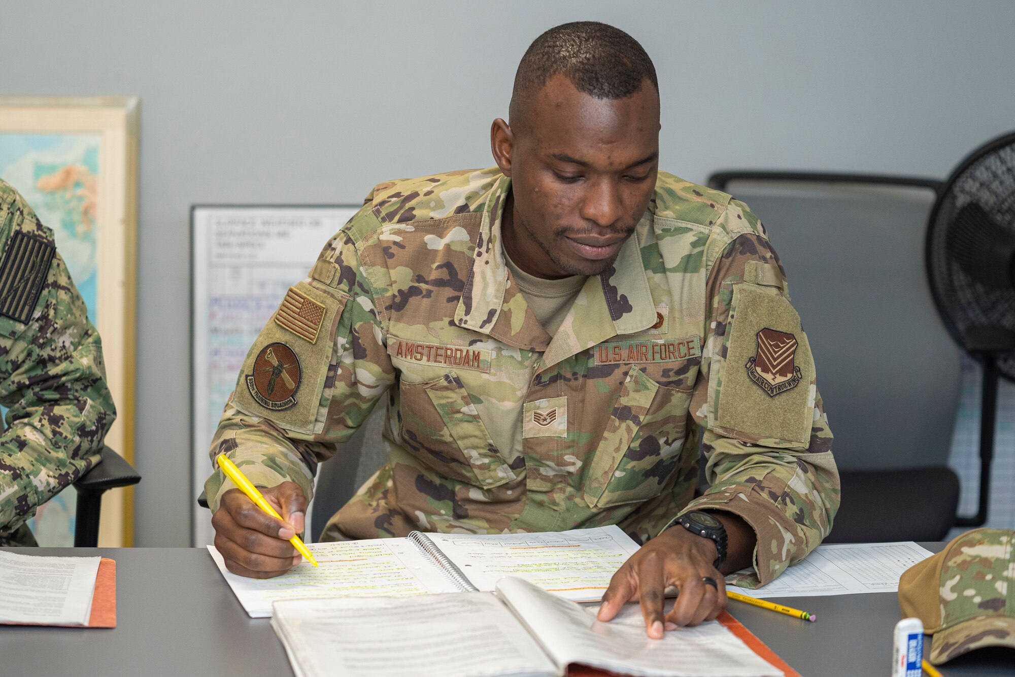 U.S. Air Force Staff Sgt. Lawrence Amsterdam, 335th Training Squadron weather student, takes notes for review at the Weather Training Complex on Keesler Air Force Base, Mississippi, Oct. 16, 2023.