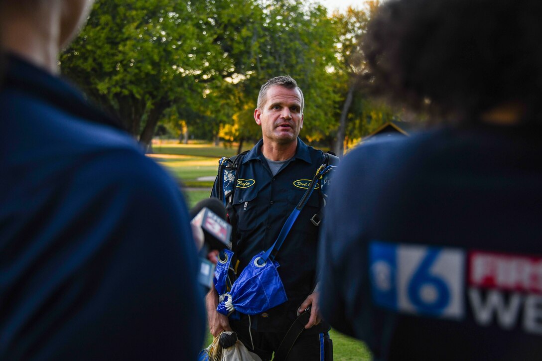 Major Paul "Rufio" Yeagley, 97th Flying Training Squadron instructor pilot, speaks to local press after completing his 2097th skydive in celebration of the 97th FTS's 25th anniversary on October 19, 2023, in Wichita Falls, Texas.
