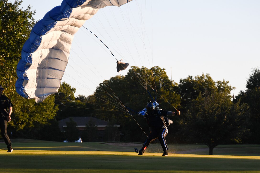 Man lands on the a field after skydiving