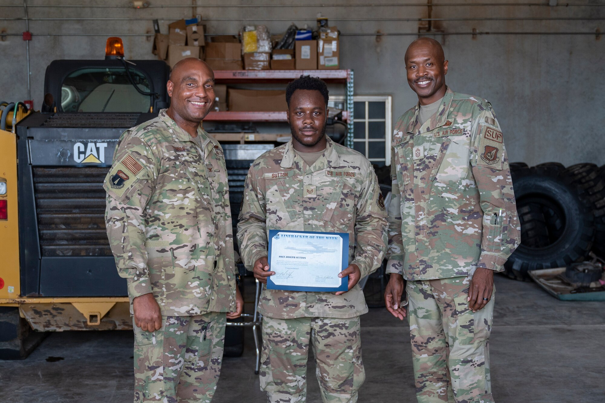 U.S. Air Force Staff Sgt. Joseph Sutton, the supervisor of Silver Flag maintenance assigned to the 36th Logistics Readiness Squadron, receives the Linebacker of the Week Award from U.S. Air Force Col. Larry Fenner, vice commander of the 36th Wing, and U.S. Air Force Chief Master Sgt. Nicholas Taylor, the command chief of the 36th Wing, at the Pacific Regional Training Center - Andersen, Guam, Oct. 17, 2023. The Team Andersen Linebacker of the Week recognizes outstanding enlisted, officer, civilian and total force personnel who have had an impact on achieving Team Andersen’s mission, vision and priorities. (U.S. Air Force photo by Senior Airman Emily Saxton)