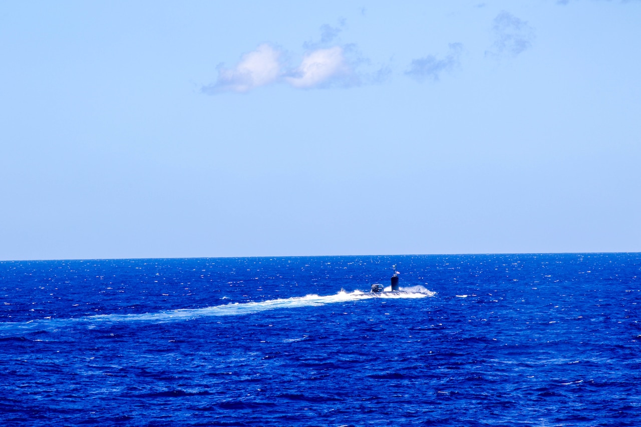 A submarine navigates in a body of water.