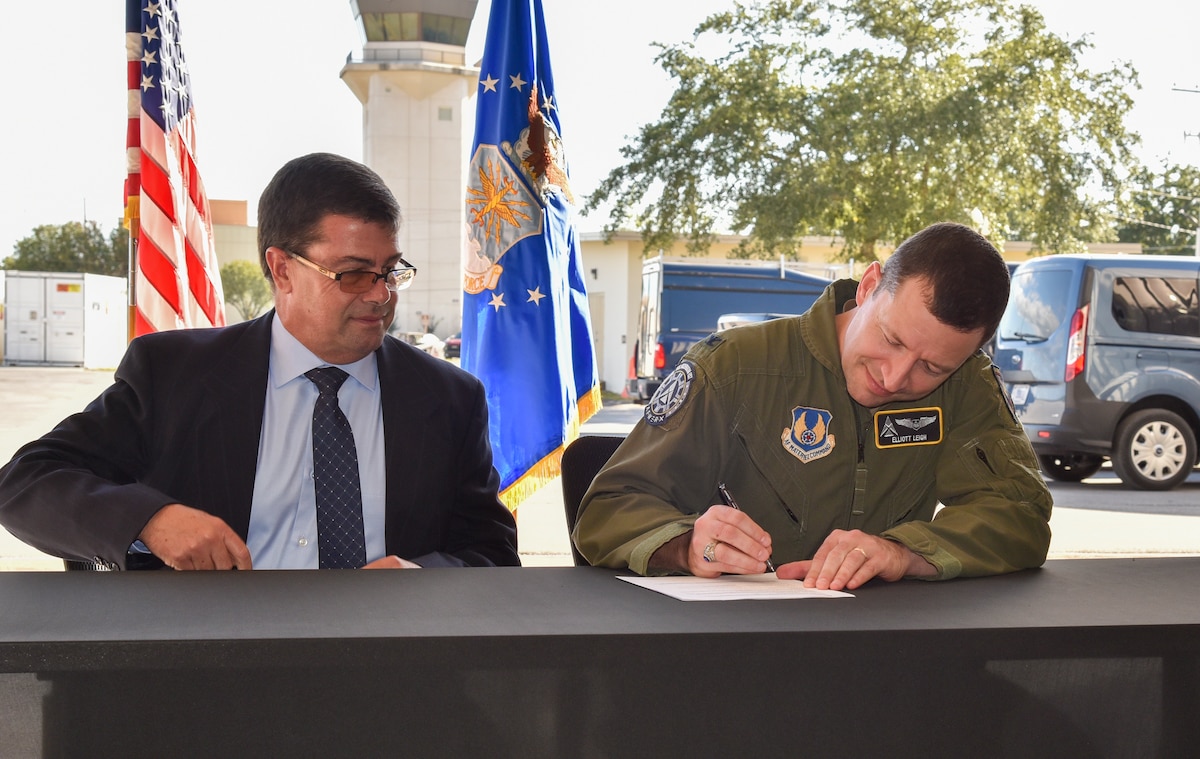 Col. Elliott Leigh, AFWERX director and chief commercialization officer for the Department of the Air Force, and John Maffei, the FAA’s acting director of Portfolio Management and Technology Development, sign the AFWERX and Federal Aviation Administration Memorandum of Understanding at Duke Field, Florida, Oct. 25, 2023.