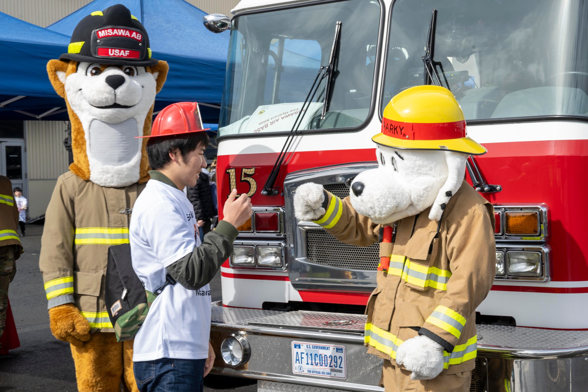 A participant fist bumps a mascot during the 2023 Misawa Special Olympics at Misawa Air Base, Japan.