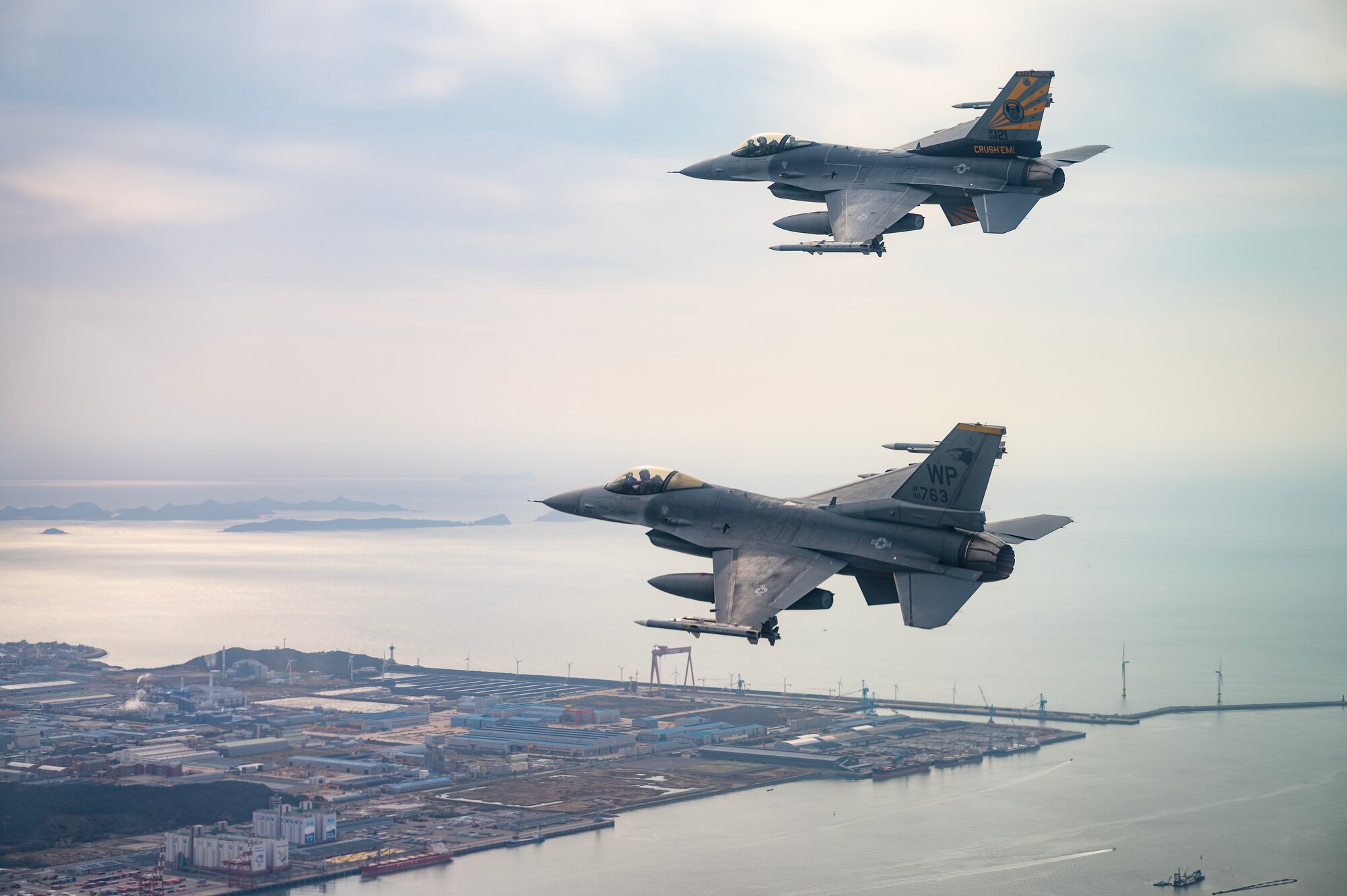 Two U.S. Air Force F-16 Fighting Falcons soar over the Republic of Korea's southern coast.