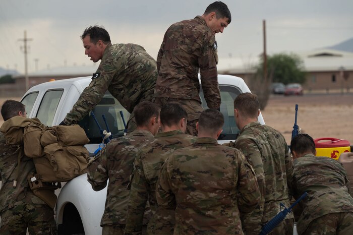 Combat Rescue Officer candidates participate in a Phase II training exercise and load supplies onto a vehicle at Davis-Monthan Air Force Base, Ariz., Oct. 17, 2023. Candidates’ teamwork was assessed to determine leadership qualities during the training exercise. (U.S. Air Force photo by Airman 1st Class Robert Allen Cooke III)