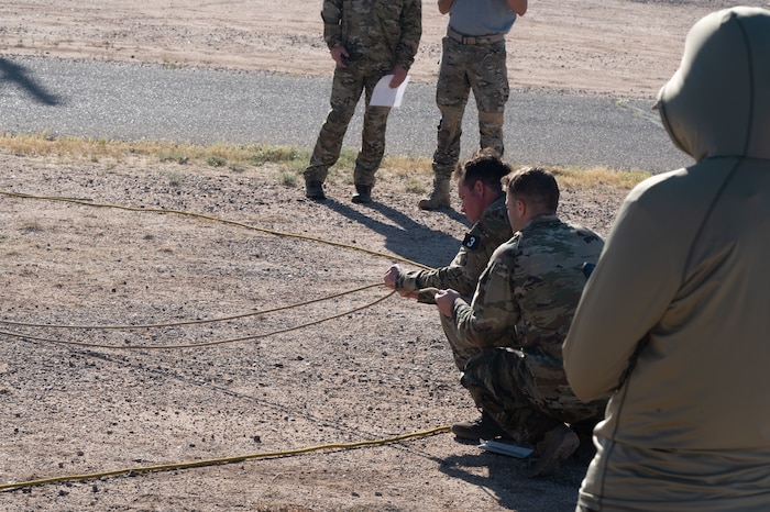 Combat Rescue Officer candidates participate in a Phase II training exercise and pull on ropes outside of Bama Park at Davis-Monthan Air Force Base, Ariz., Oct. 16, 2023. Candidates’ dexterity was assessed during the training exercise. (U.S. Air Force photo by Airman 1st Class Robert Allen Cooke III)