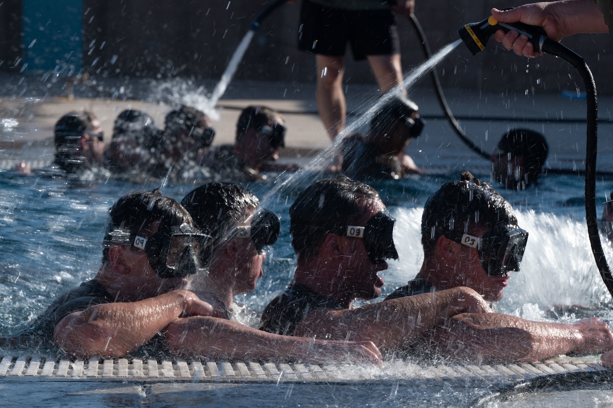 Combat Rescue Officer candidates participate in a Phase II training exercise training exercise and perform an intense water drill at Davis-Monthan Air Force Base, Ariz., Oct. 17, 2023. Candidates’ ability to handle intense pressure was assessed during the exercise. (U.S. Air Force photo by Airman 1st Class Robert Allen Cooke III)