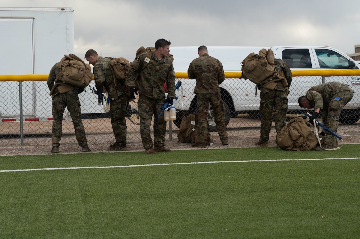 Combat Rescue Officer candidates participate in a Phase II training exercise and put on gear and supplies at Davis-Monthan Air Force Base, Ariz., Oct. 17, 2023. Candidates’ ability to follow instructions was assessed to determine leadership qualities during the training exercise. (U.S. Air Force photo by Airman 1st Class Robert Allen Cooke III)