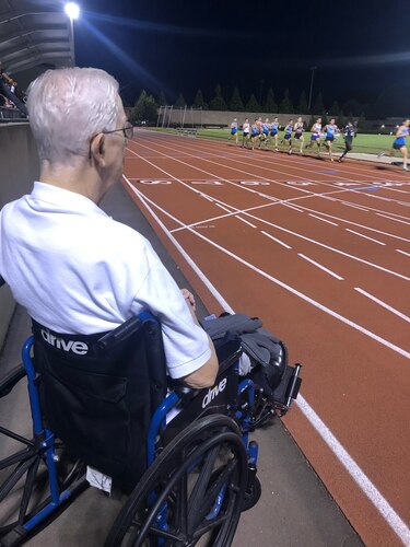 Joseph Michalski watches from the sidelines as his grandson, U.S. Air Force Airman 1st Class Daniel Michalski, competes in a collegiate track and field meet at Princeton University in 2019. Michalski credits his grandfather as his source of inspiration on the track. (Courtesy photo)