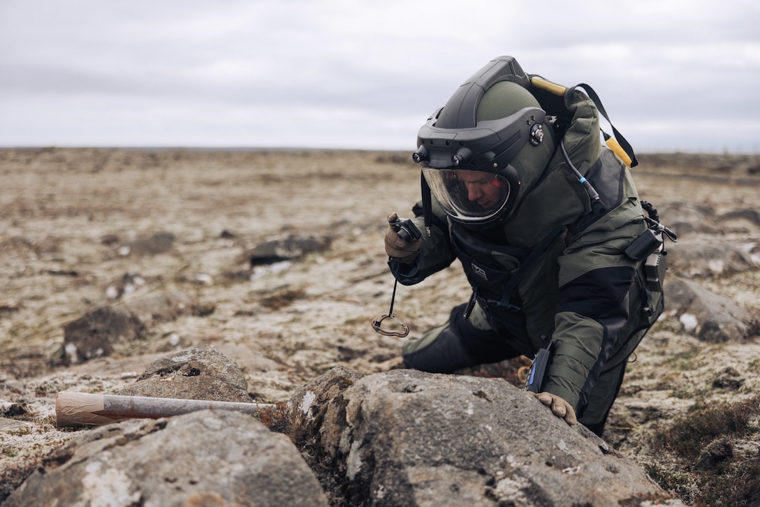 U.S. Marine Corps Staff Sgt. Mark Frick, a native of Baltimore, Maryland and explosive ordnance disposal team leader with the 26th Marine Expeditionary Unit (Special Operations Capable) (26MEU(SOC)), photographs a neutralized simulated improvised explosive device during Exercise Northern Challenge 2023, Keflavik Airport, Iceland, Sept. 22, 2023. Northern Challenge 23 is an Icelandic Coast Guard-led bomb disposal exercise, hosted to train teams from over a dozen nations with response to incidents involving simulated improvised and military explosive devices. The San Antonio-class amphibious transport dock ship USS Mesa Verde (LPD 19), assigned to the Bataan Amphibious Ready Group and embarked 26MEU(SOC), under the command and control of Task Force 61/2, is on a scheduled deployment in the U.S. Naval Forces Europe area of operations, employed by U.S. Sixth Fleet to defend U.S., Allied, and partner interests. (U.S. Marine Corps photo by Cpl. Kyle Jia)