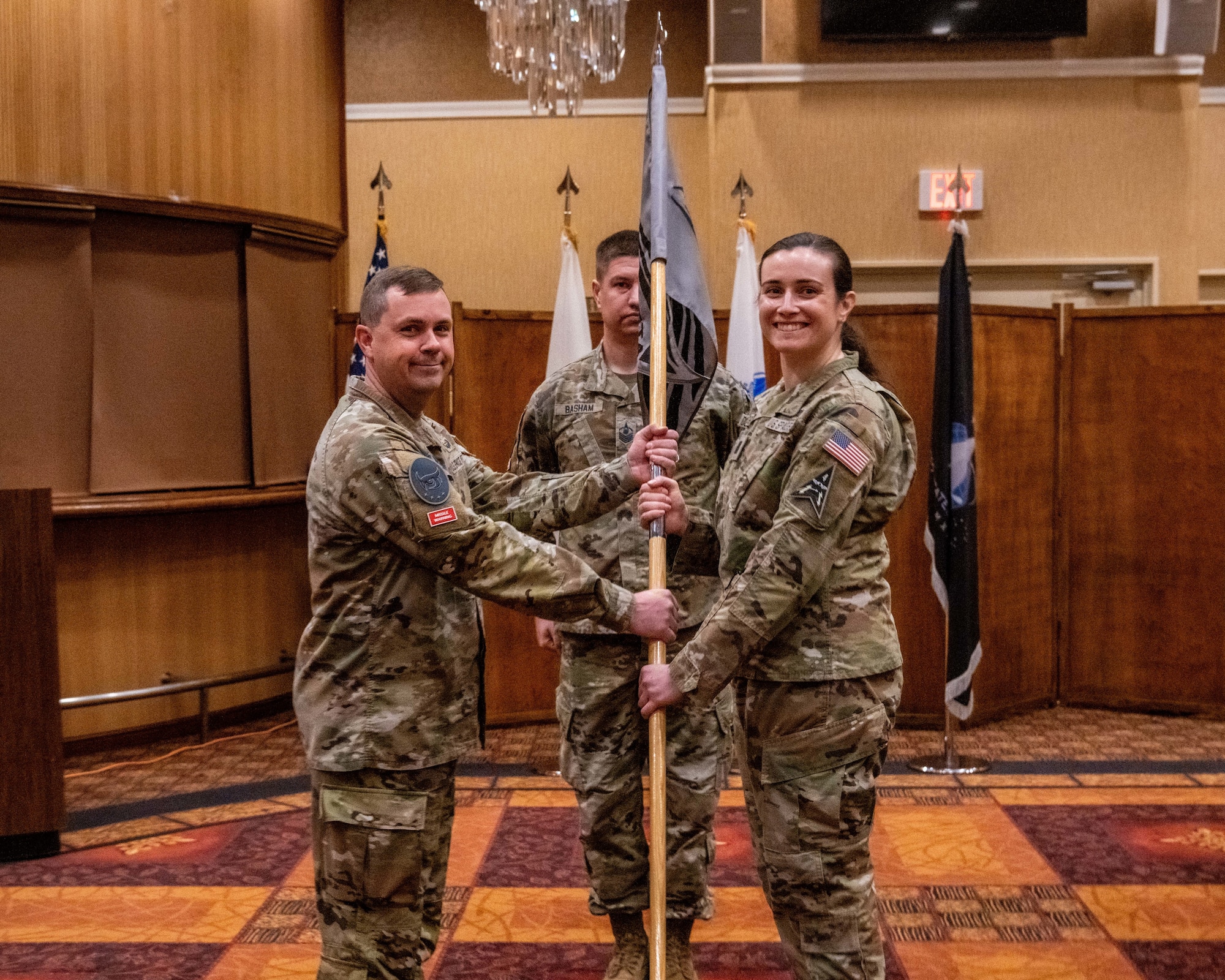 U.S. Space Force Lt. Col. Michael Provencher, left, 5th Space Warning Squadron commander, passes the guidon to Capt. Madison Duke-Bruechert, right, 5th Space Warning Squadron Detachment 4 commander, during an activation and assumption of command ceremony at Misawa Air Base, Japan, Oct. 25, 2023.