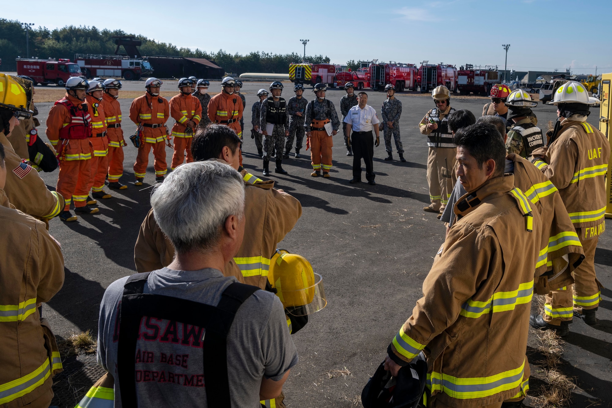 A group of firefighters standing together for a briefing.